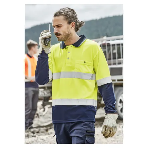 Worker in a Syzmik hi vis spliced polo with reflective tape