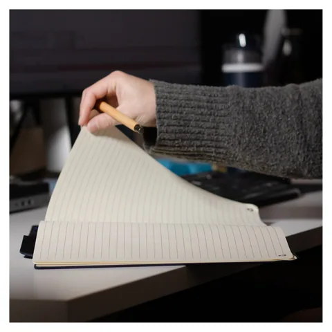 A4 notebook being opened on a desk